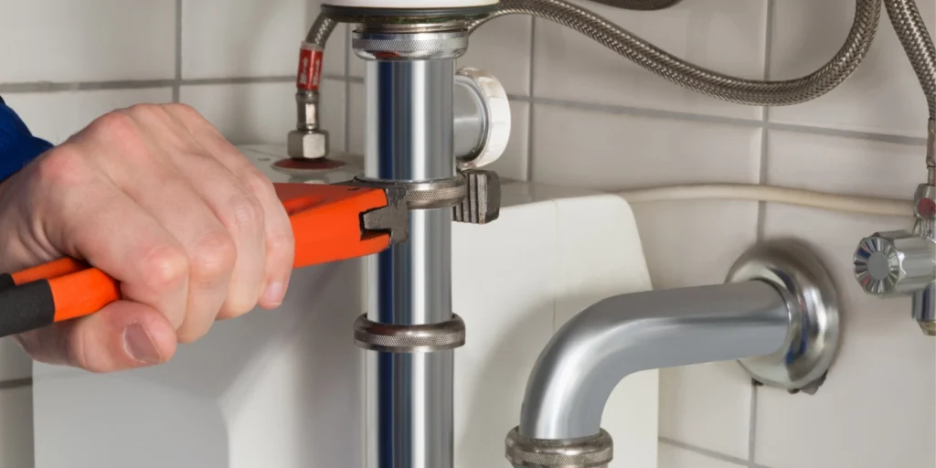 Plumber fixing a pipe.
