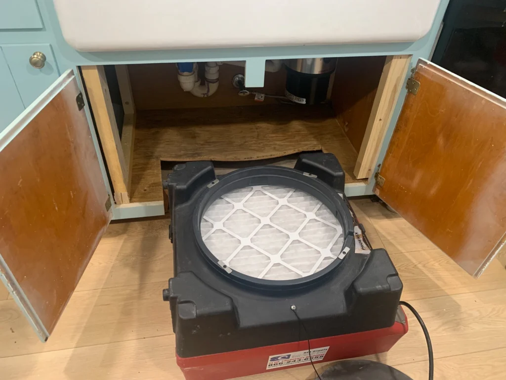 First In Restoration cleaning air under a cabinet