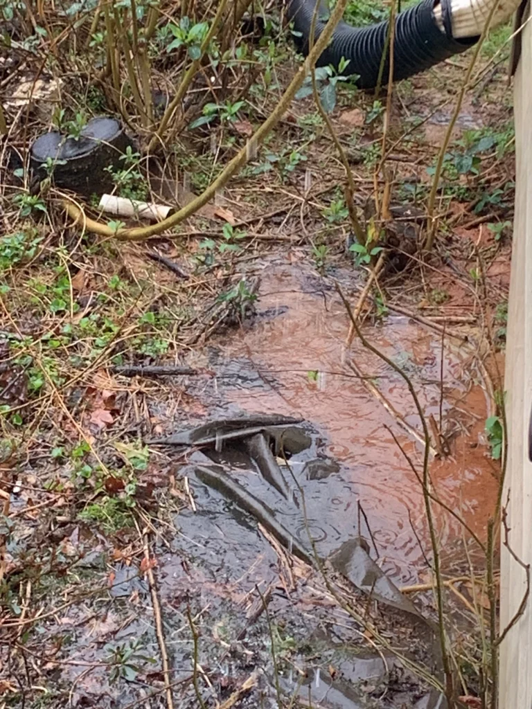 Water pouring out of gutters forming around foundation